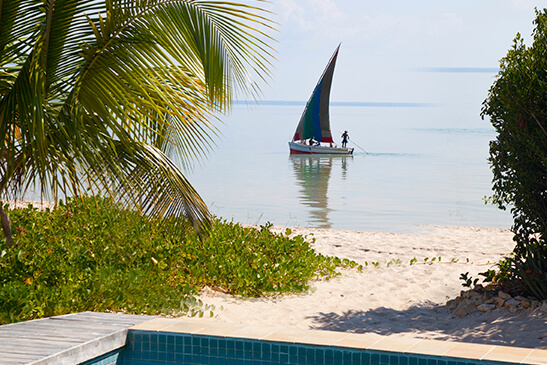 Azura-Benguerra-Luxury-Beach-Villa-view-from-pool-to-beach-with-dhow